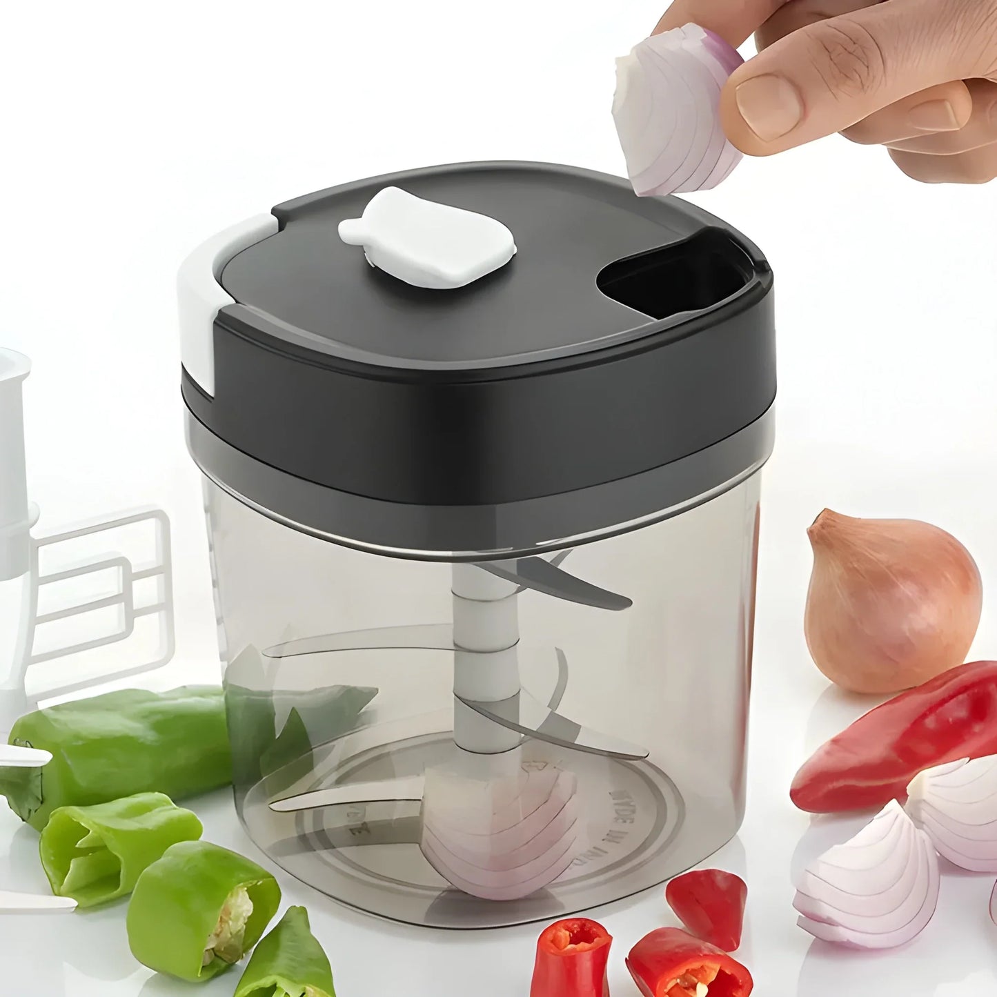 Manual food chopper with dark gray lid and clear bowl; white chopping blade insert