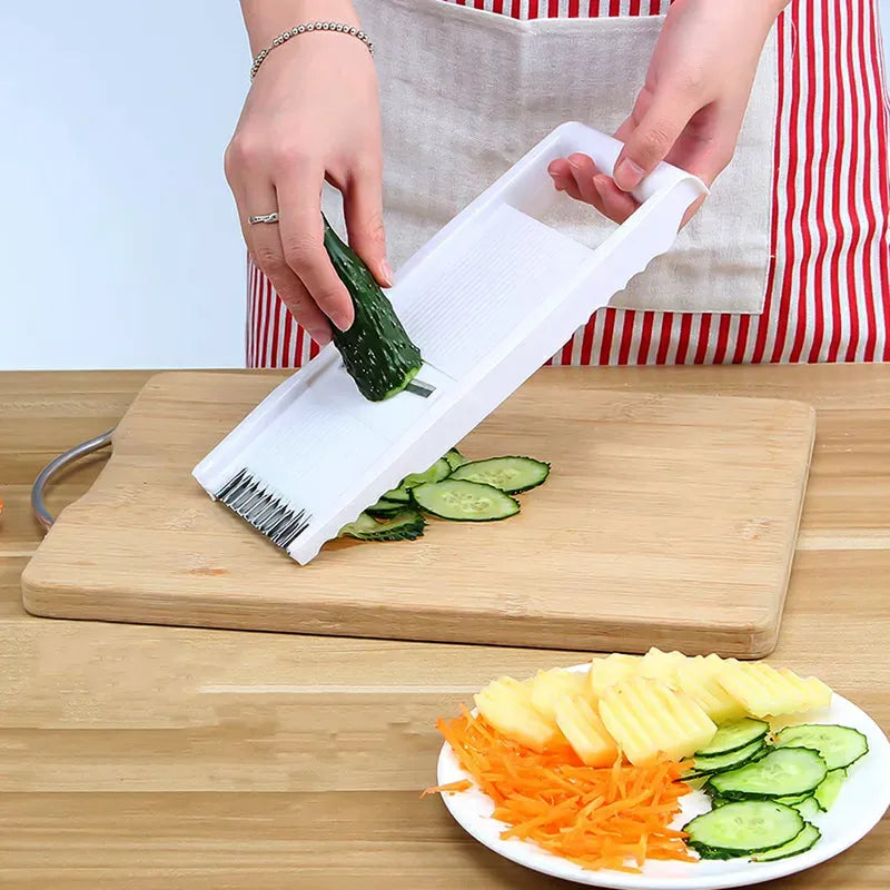 Kitchen grater set with white holder and multi-size blades, grating cucumber on board