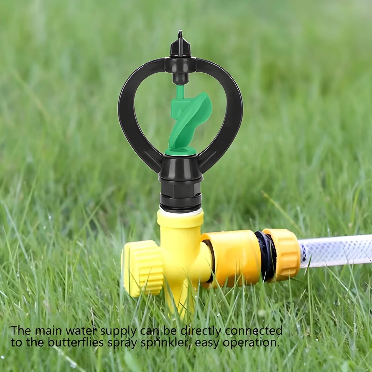 Yellow lawn sprinkler with black circular head, green nozzle, and hose connector