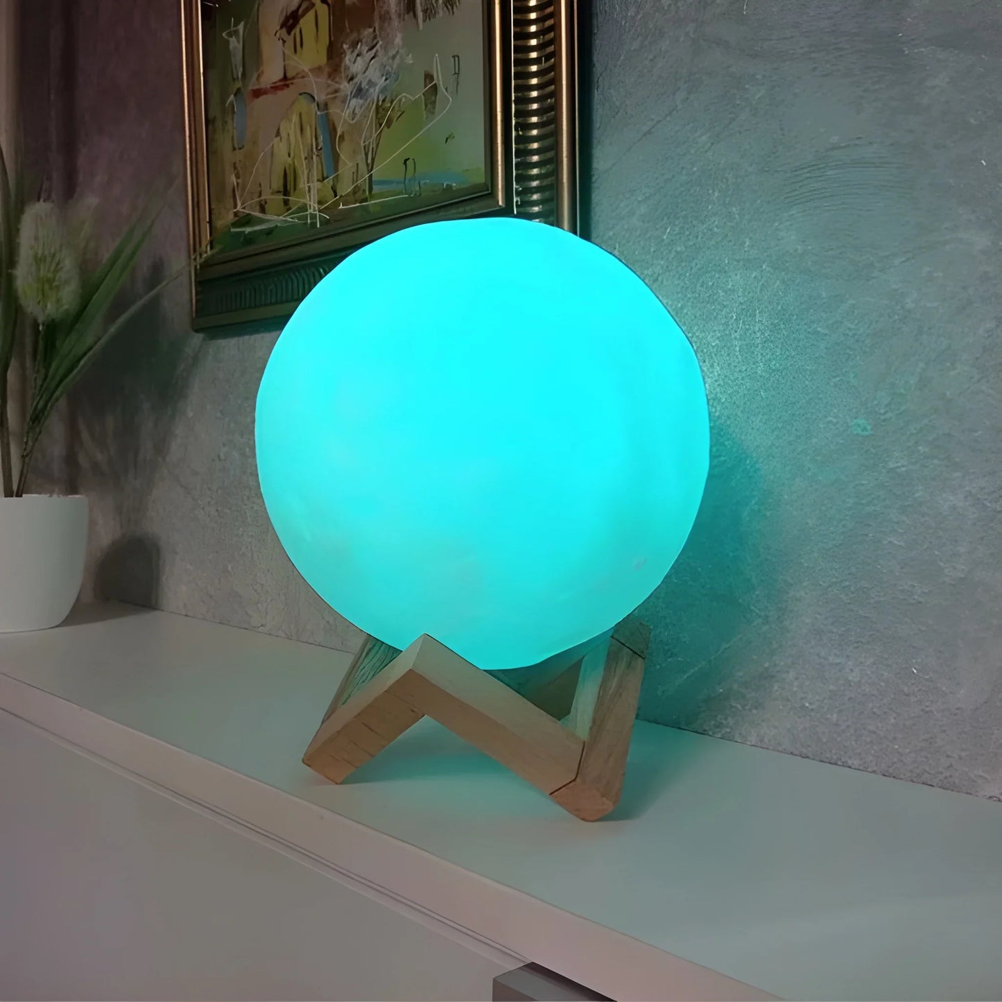 Glowing moon lamp with round light orb on a wooden stand.