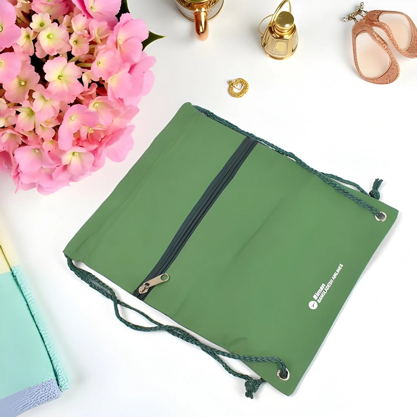 Green drawstring shoulder pouch with zip pocket and stitched flap