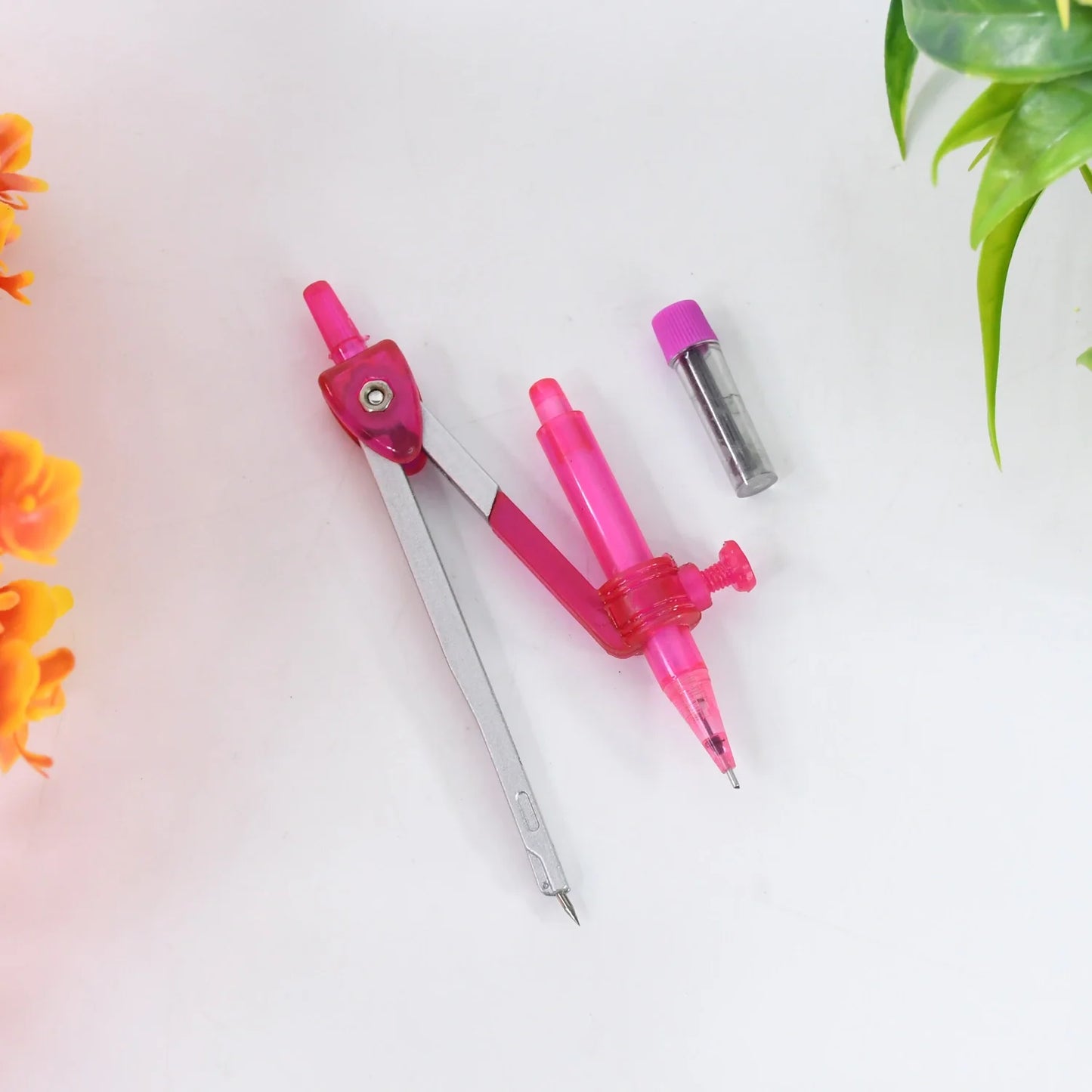 Student compass set with pink plastic clip arm and metal point legs