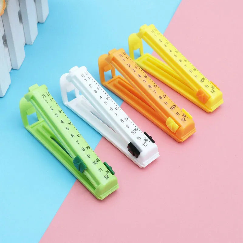 Food packet sealing clips, set of 4 plastic clips in green, white, orange, and yellow