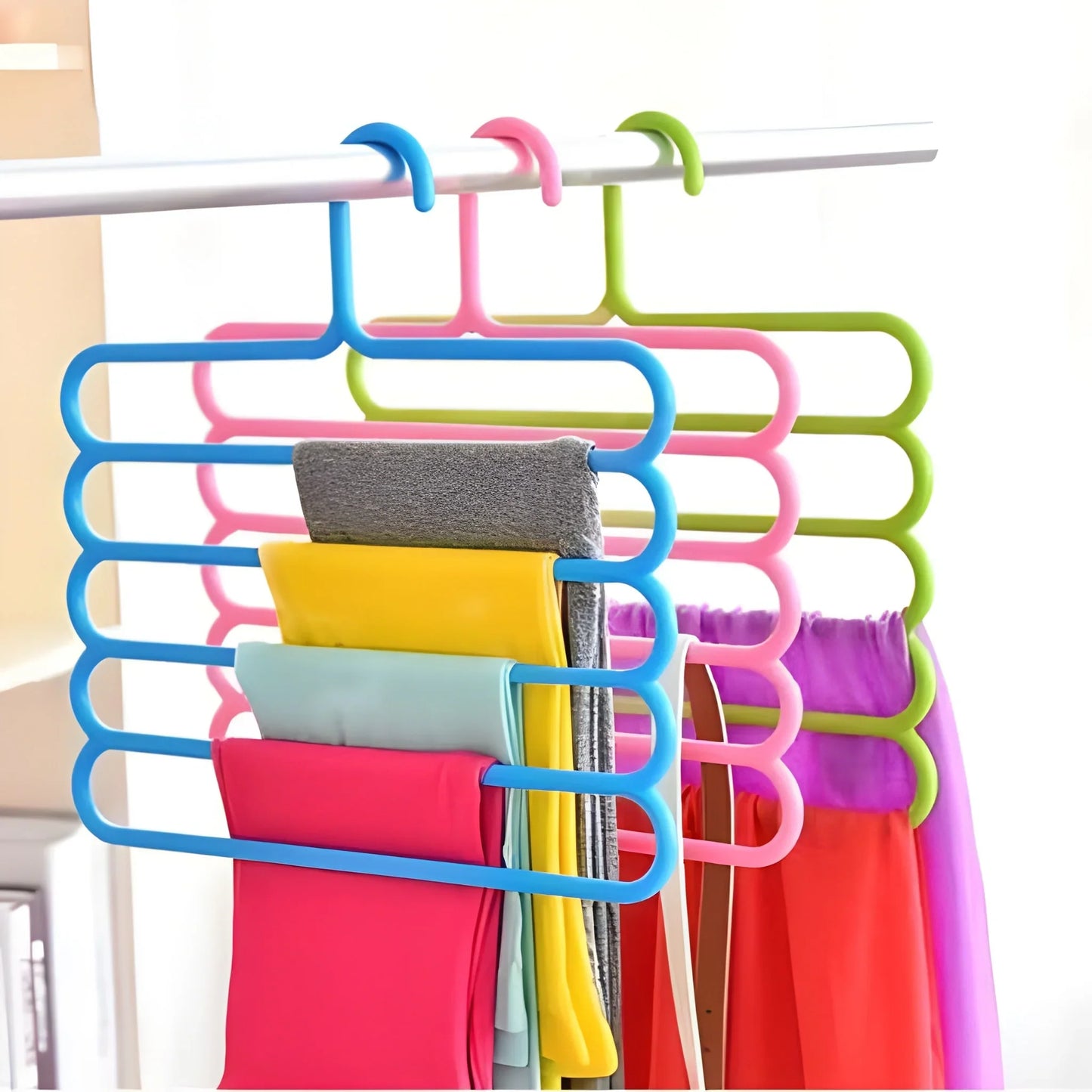 Assorted plastic multipurpose hangers, multicolor clips holding folded fabrics