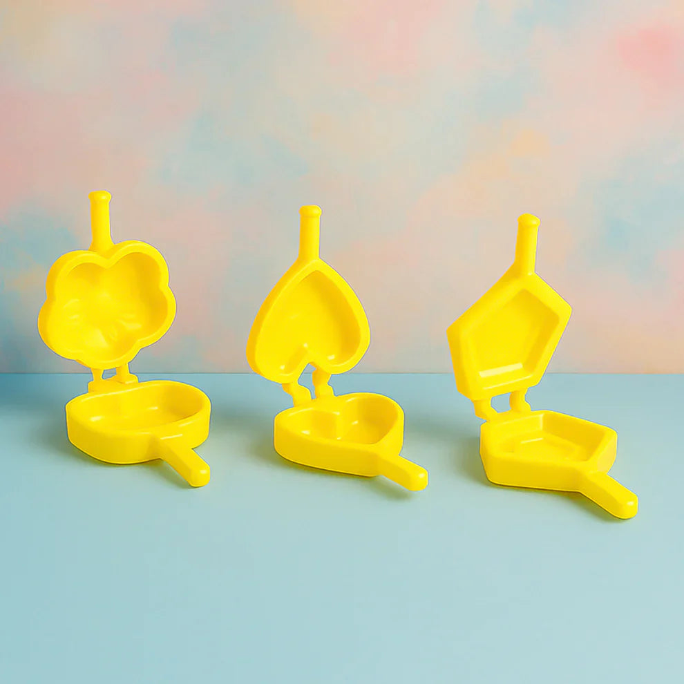 Plastic cookie cutter set with three yellow shapes on bases