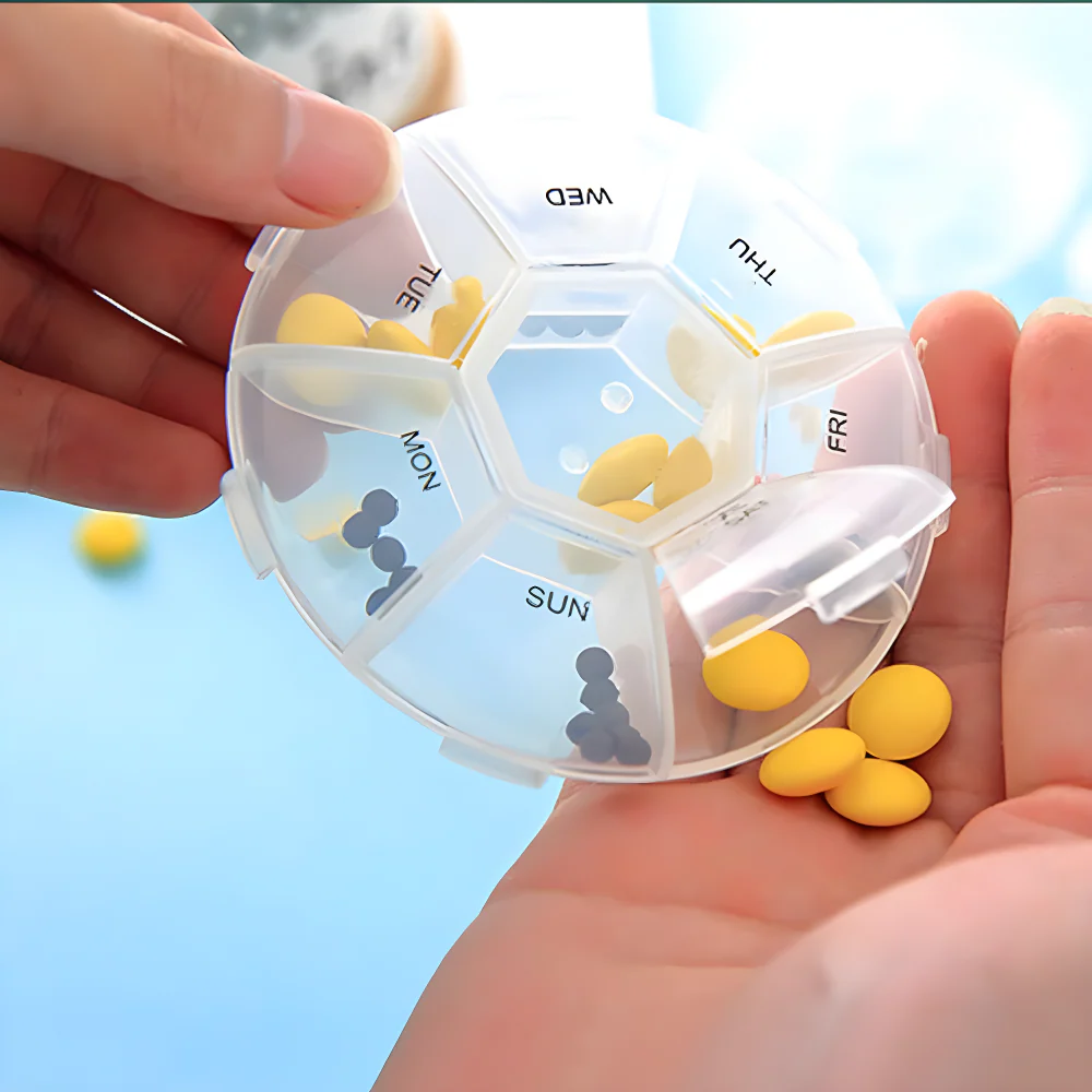 7-sided pill organizer with labeled compartments, held in a hand