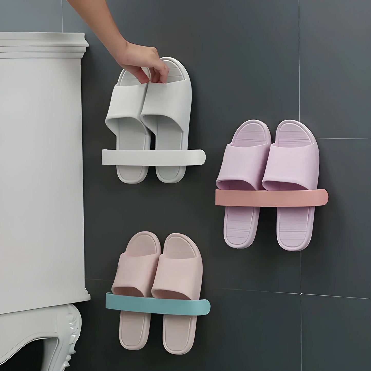 Adhesive multi-hook rack with white hooks holding slippers