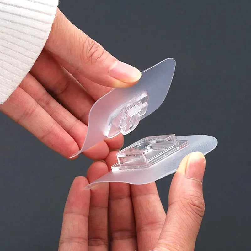 Clear adhesive plastic wall hooks, two pieces with hanging clips.