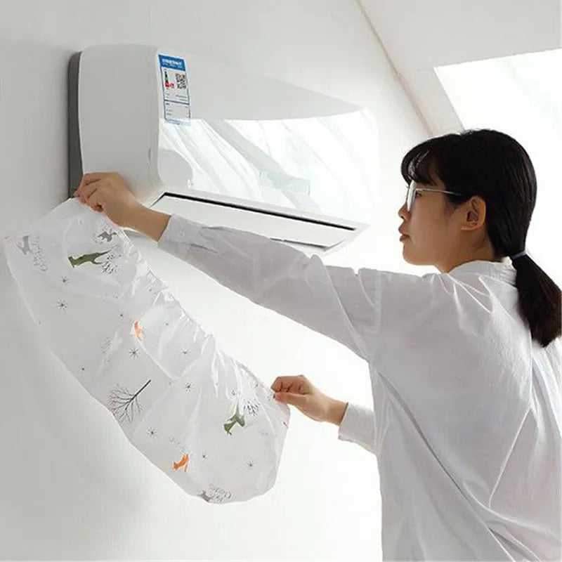 White air conditioner dust cover sheet with colorful cartoon graphic, draped over indoor unit