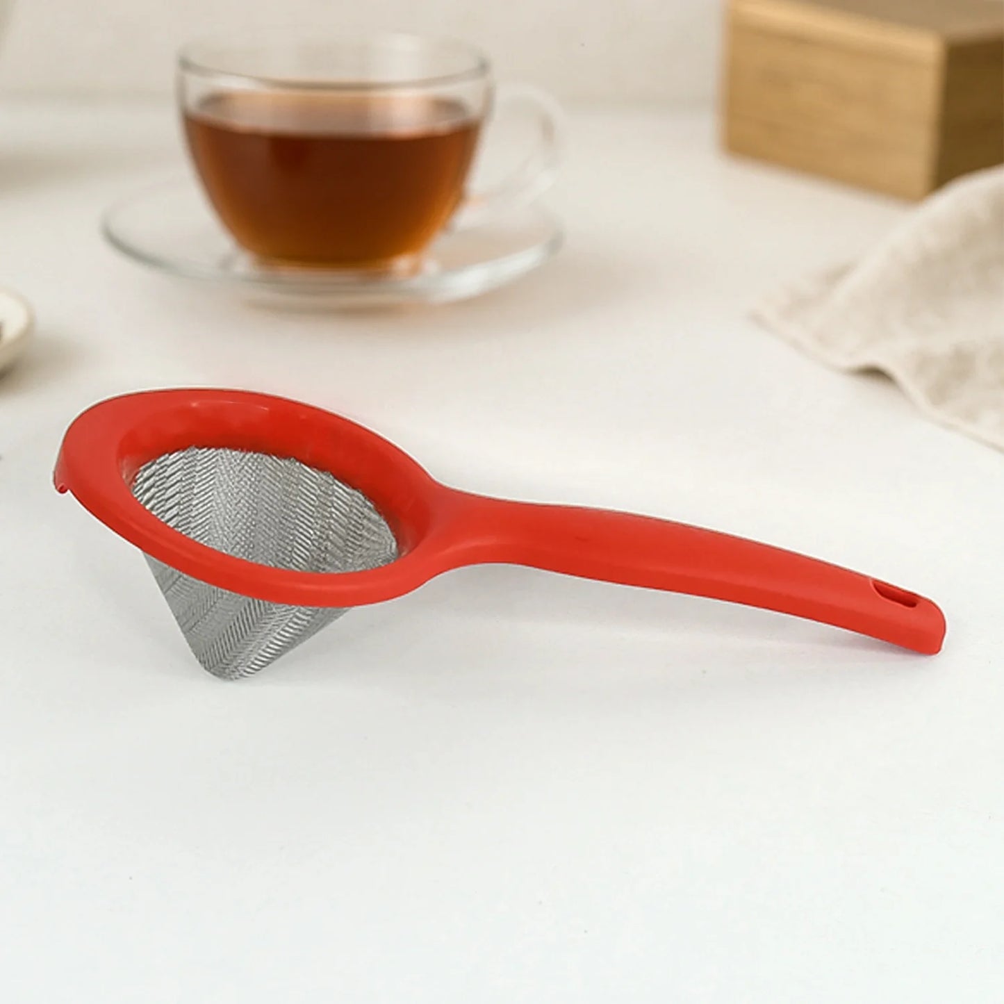 Tea mesh strainer with red handle and fine metal mesh cup