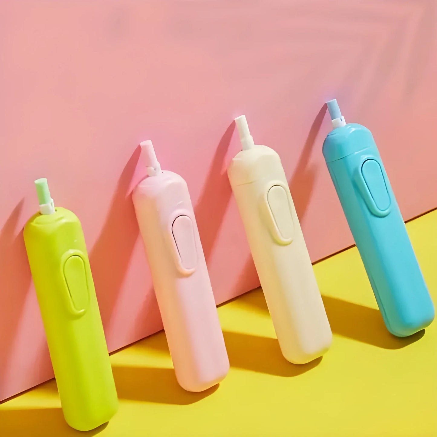 Handheld electric eraser pens in yellow, pink, cream, and blue with side buttons