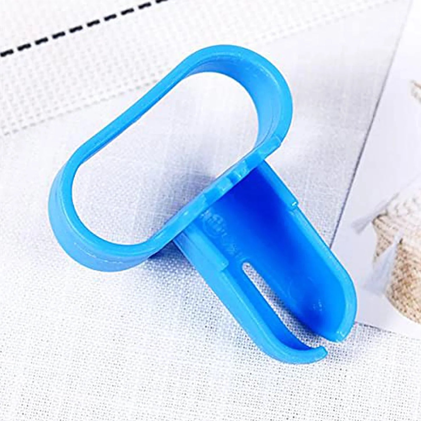 Blue plastic balloon tying tool