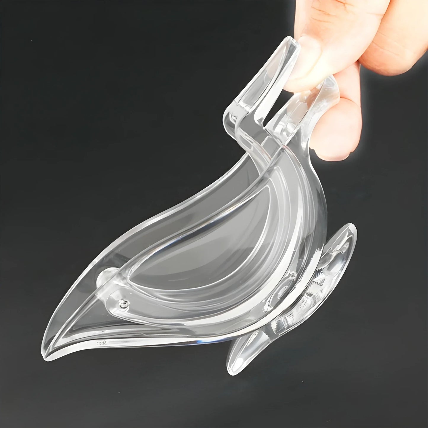 Bird-shaped citrus juicer, clear plastic with ergonomic handle and curved beak spout