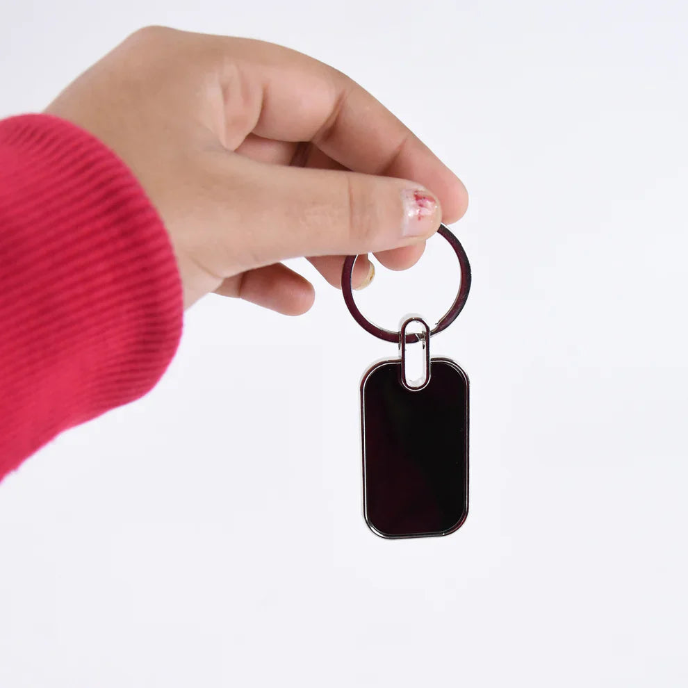 Metal keychain with blank rectangular dark tag and split key ring