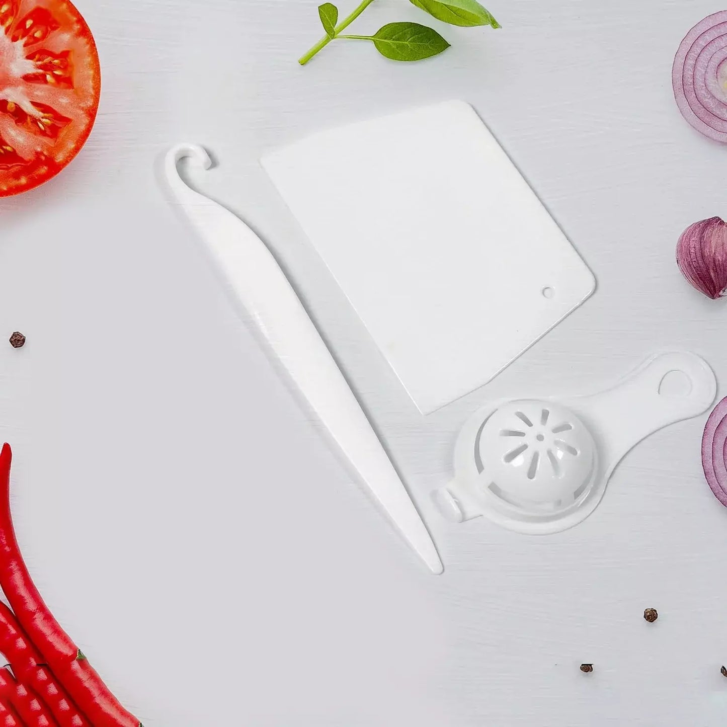 Cake decorating tools set with white spatula, scraper, and round icing tip