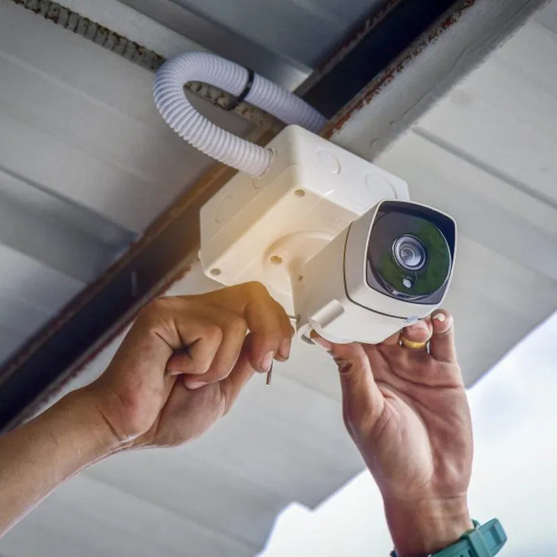 Camera mounting box with dome security camera, hands holding bracket for installation
