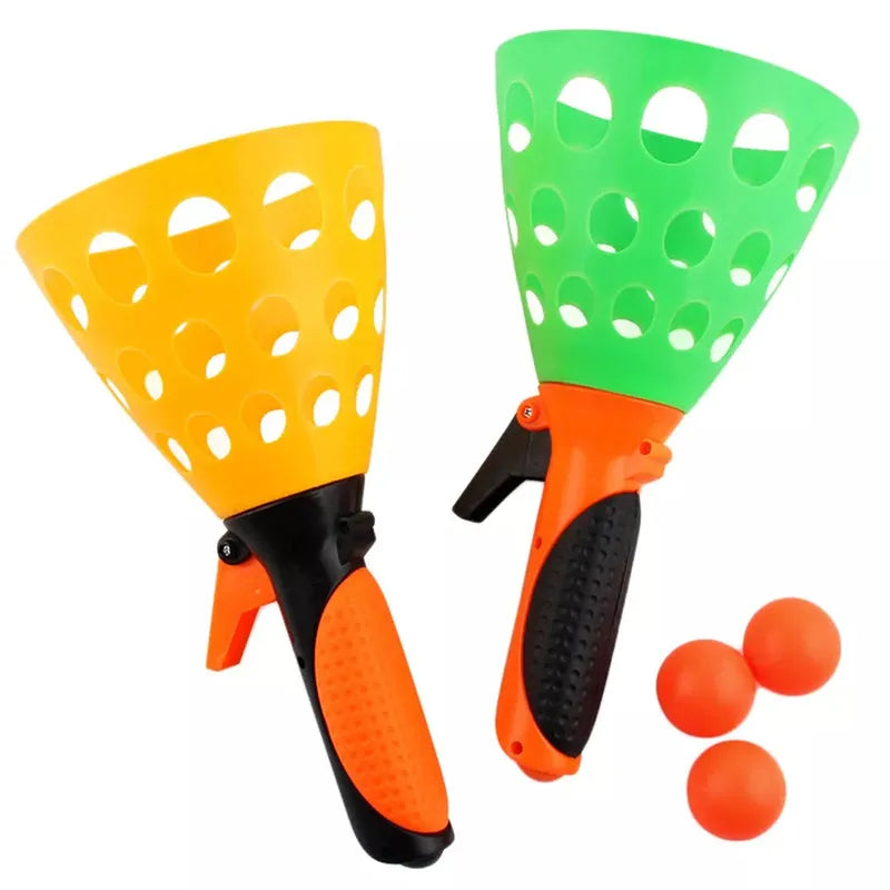 Catapult butt ball toy with green and orange launcher cups, black handles
