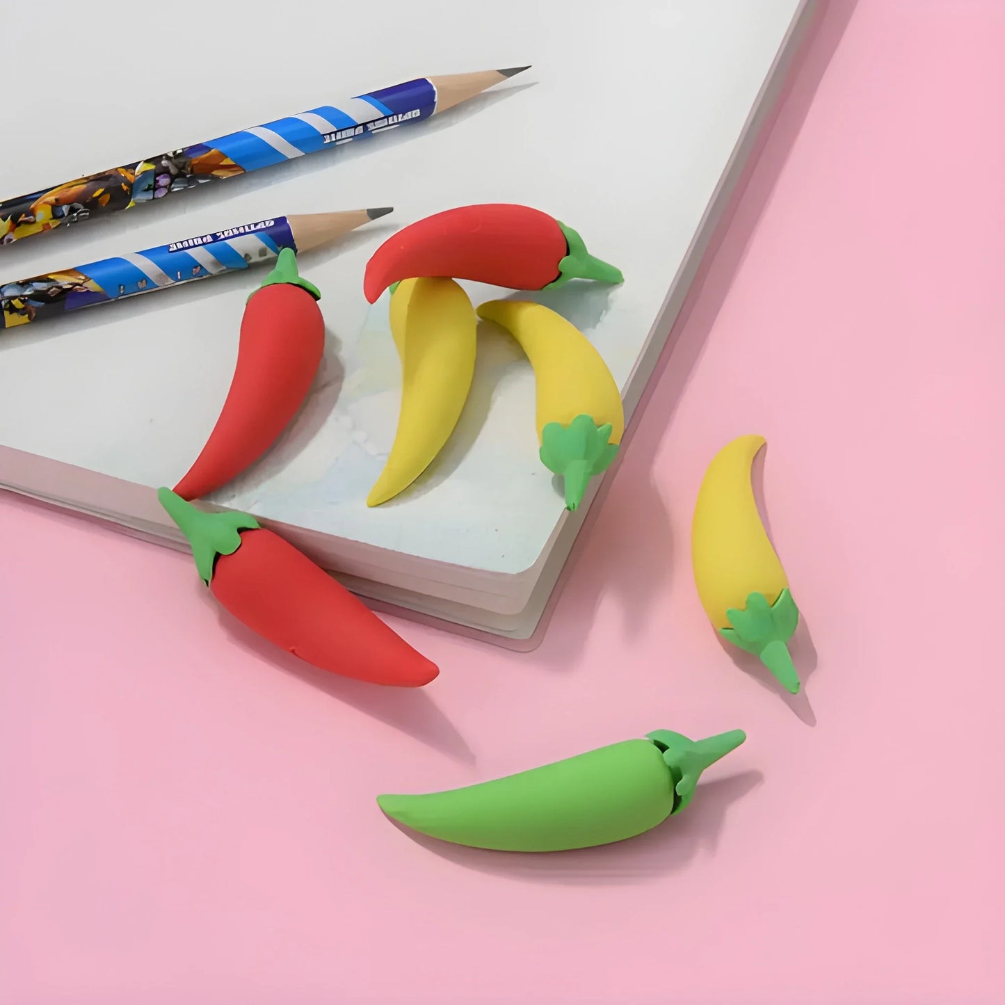 Chili-shaped eraser set in red, yellow, and green, with small stem details.