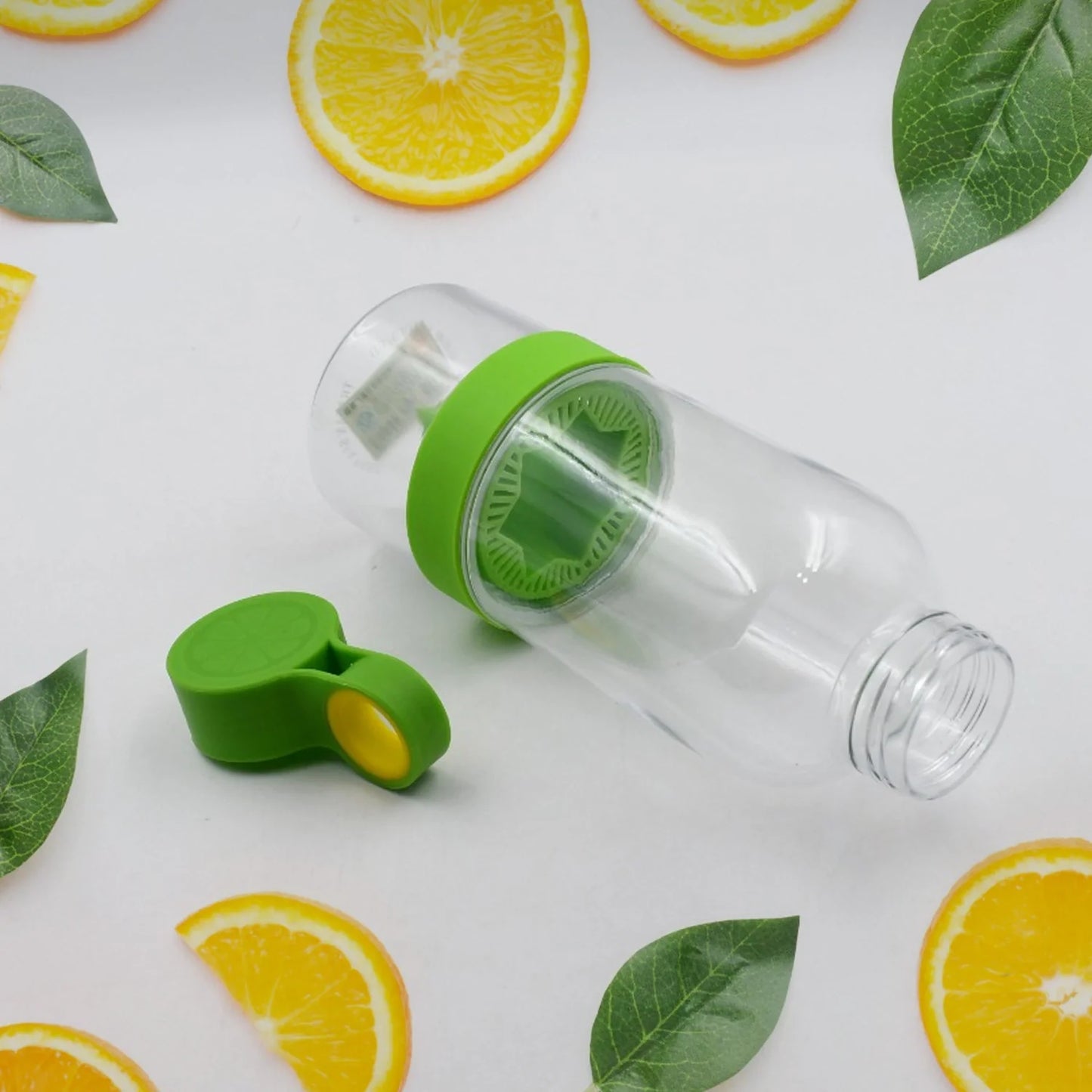 Clear infuser water bottle with green lid and citrus infuser insert