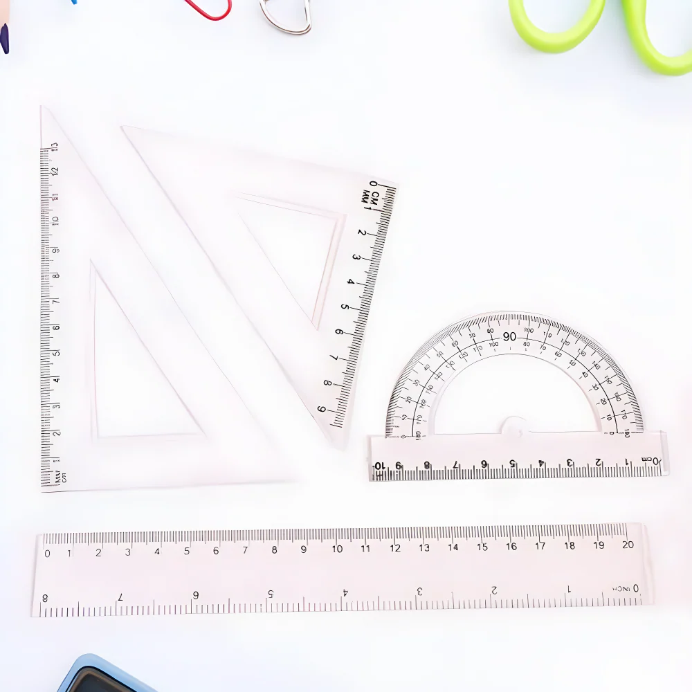 Clear plastic geometry set with triangles, ruler, and protractor with measurement markings