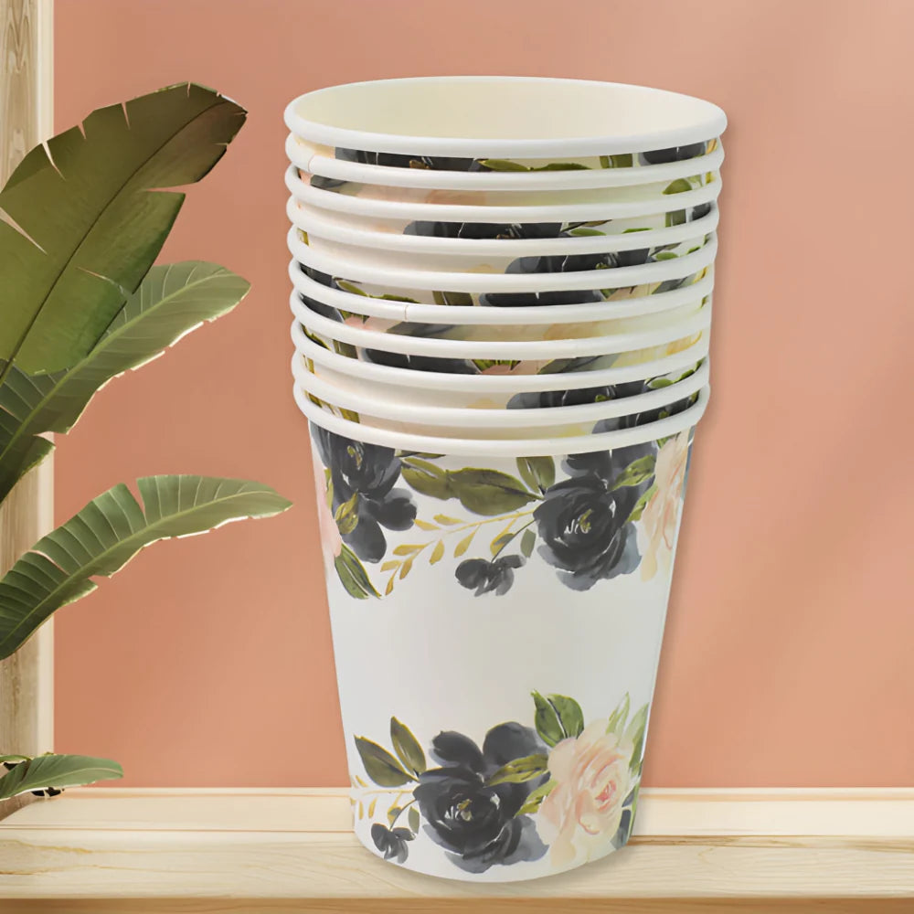 Stack of white paper cups with floral pattern in green and black, disposable drink cups
