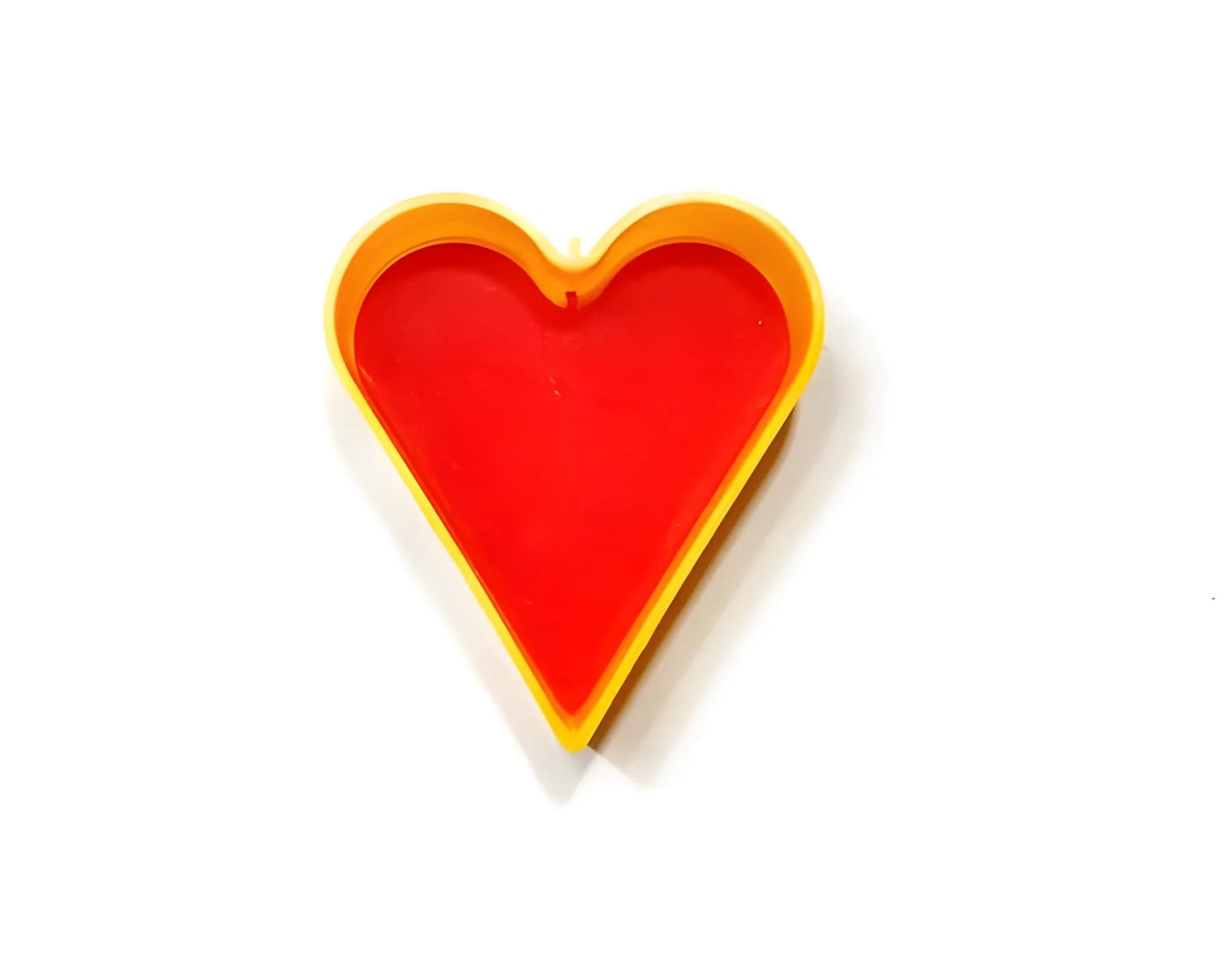 Heart-shaped cookie cutter with red heart insert and yellow outline