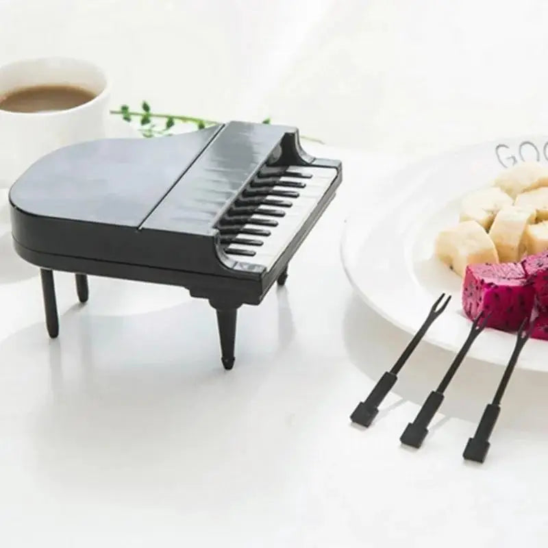 Piano-shaped fruit fork set with black mini fork handles and fork tines