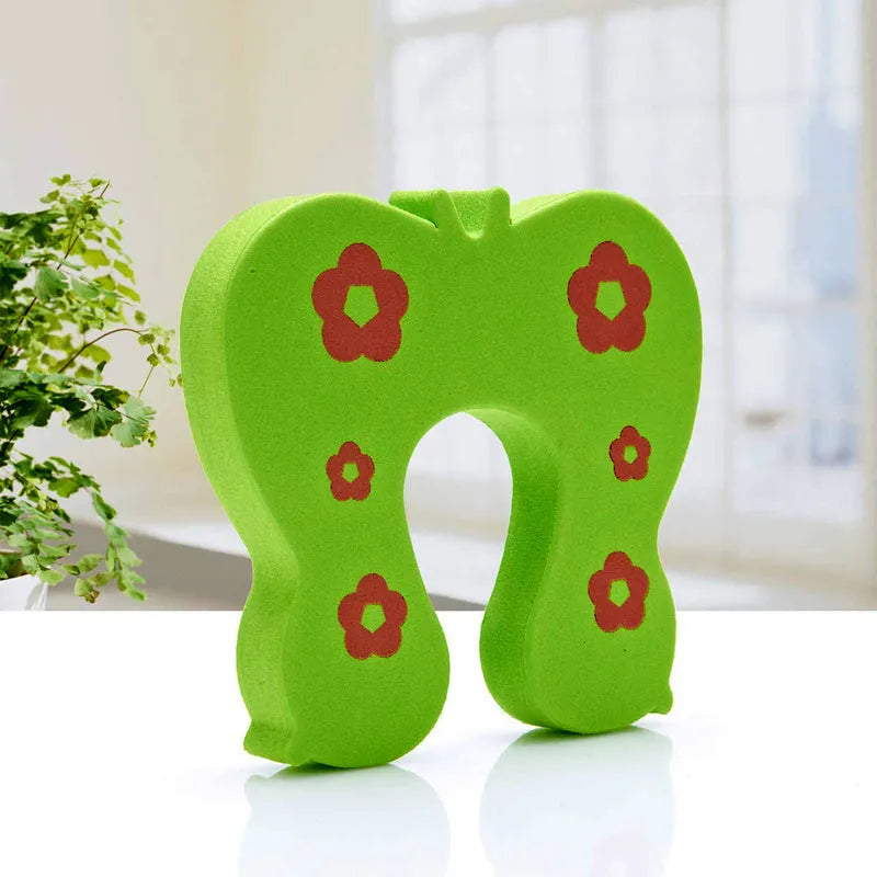 Green children's door stopper with red floral pattern and arch cutout