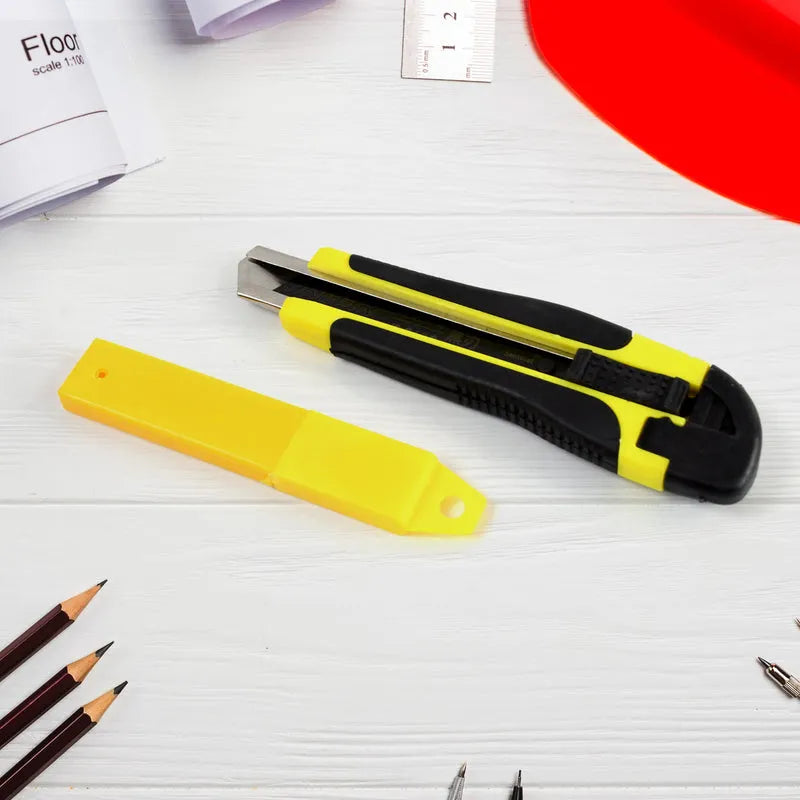 Yellow and black utility cutter knife with retractable blade and safety slider