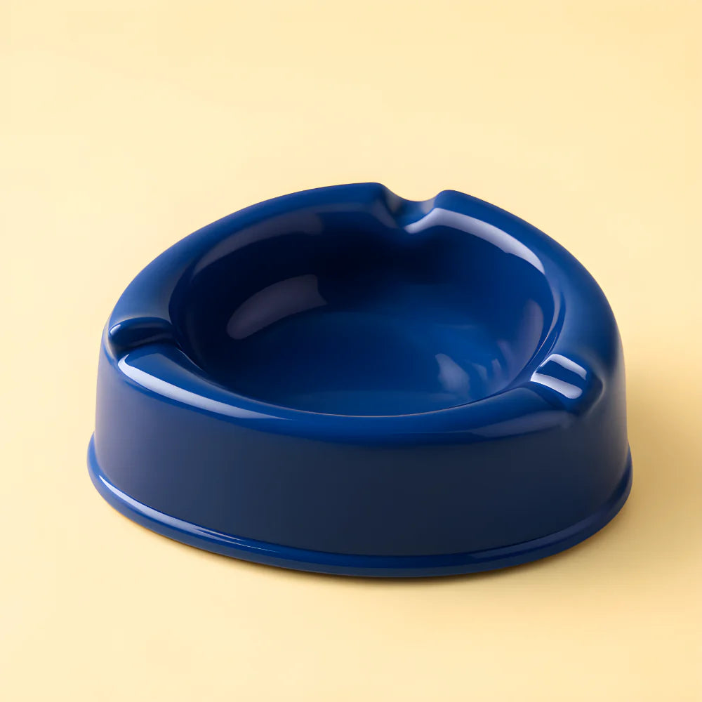 Dark blue ceramic ashtray with round bowl and glossy finish