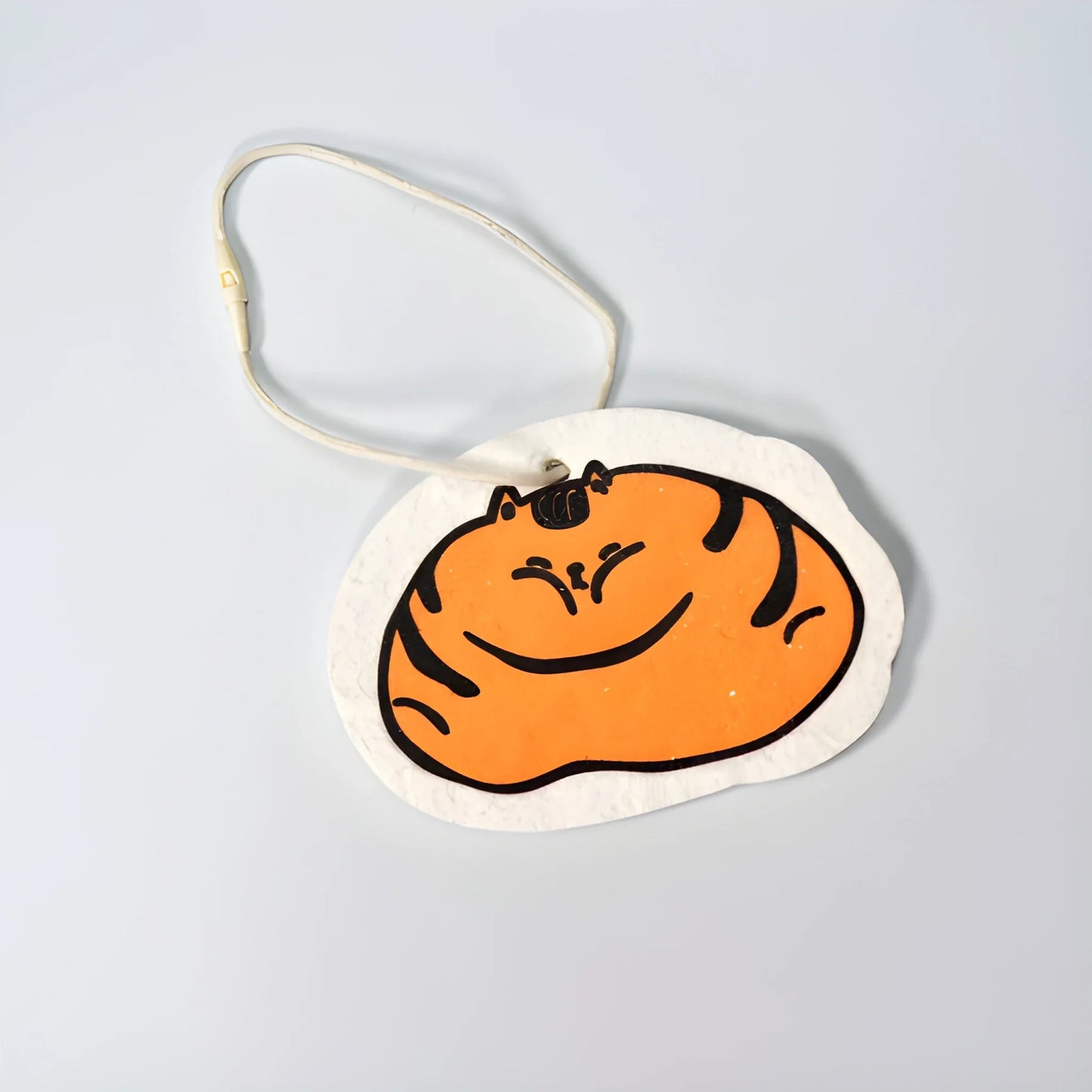 White eco scouring sponge with orange cartoon cat face and loop handle
