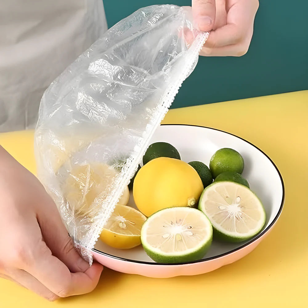Elastic stretch food cover with ruffled edge, secured over a bowl of citrus fruit