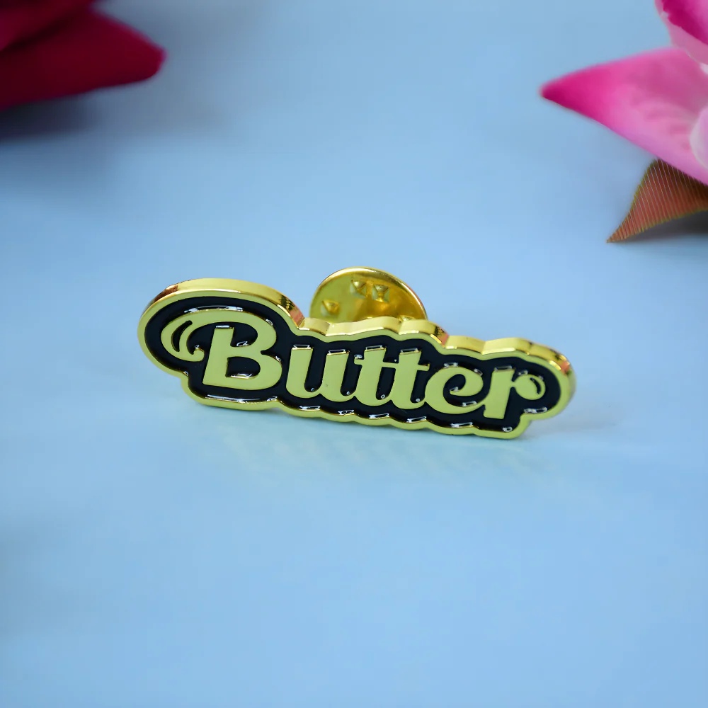 Enamel fashion badge pin with gold frame and dark center Butter logo