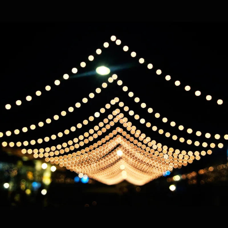 LED string lights forming a diamond festival canopy, warm white bulbs