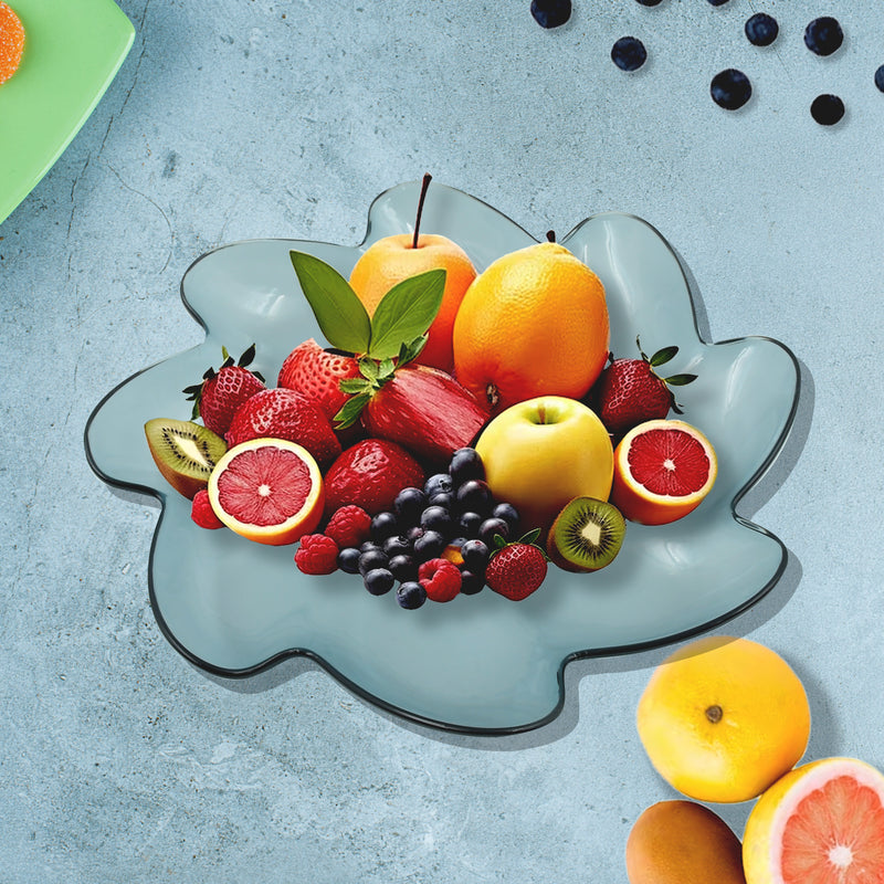 Flower-shaped light blue snack plate with scalloped edges, shown with fruit.