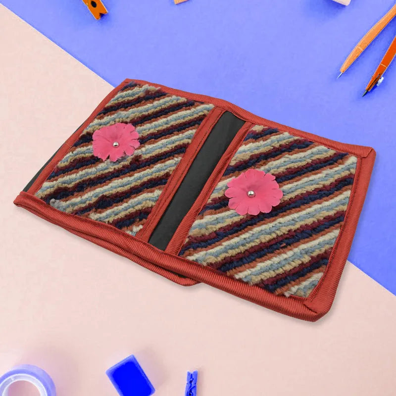 Foldable hanging organizer with three fabric compartments, striped panels and pink flower accents
