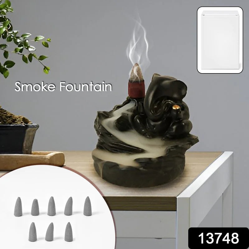 Ganesha smoke fountain idol, dark resin figurine with upward smoke plume