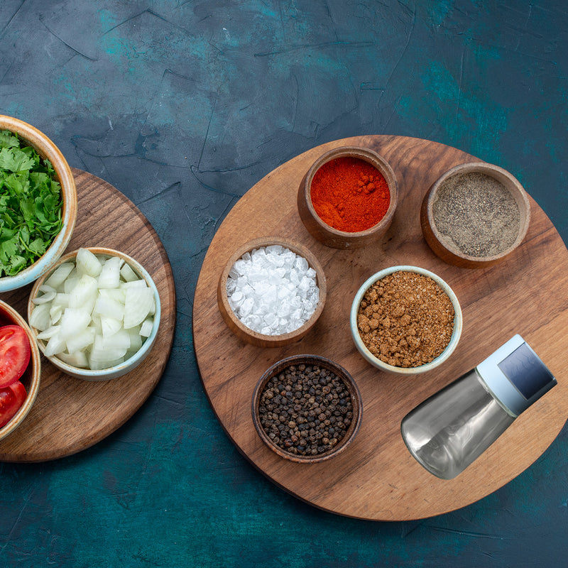 Glass salt shaker set with wooden spice board and metal-topped shakers