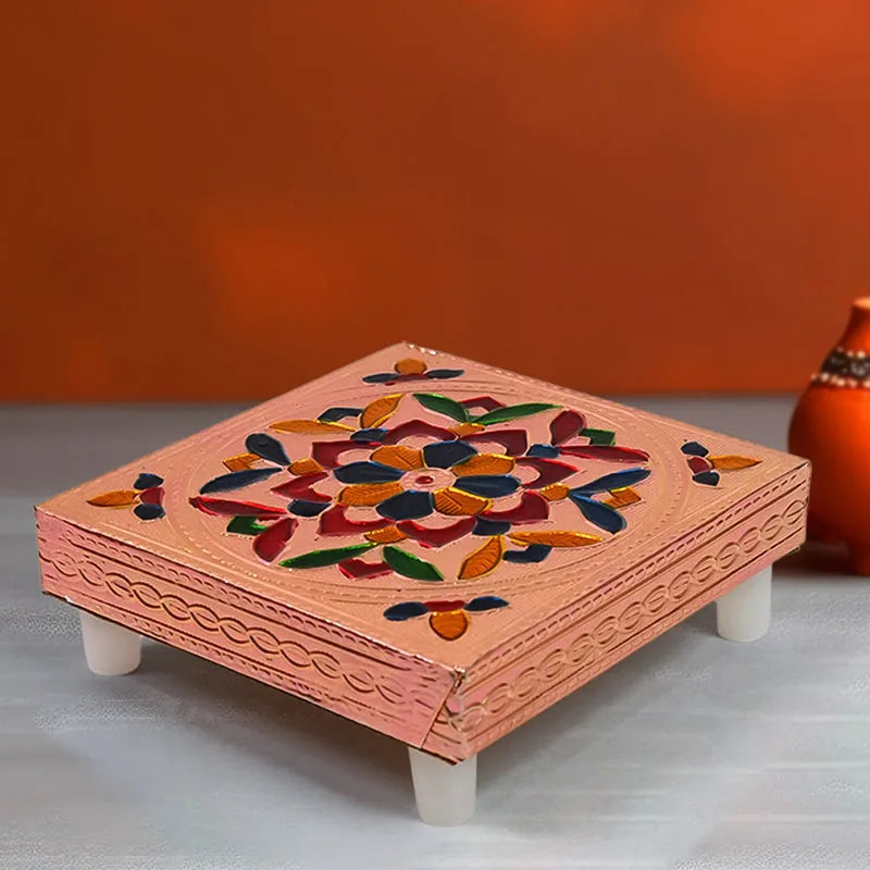 Meenakari wooden chowki with painted floral motif on a light pink base