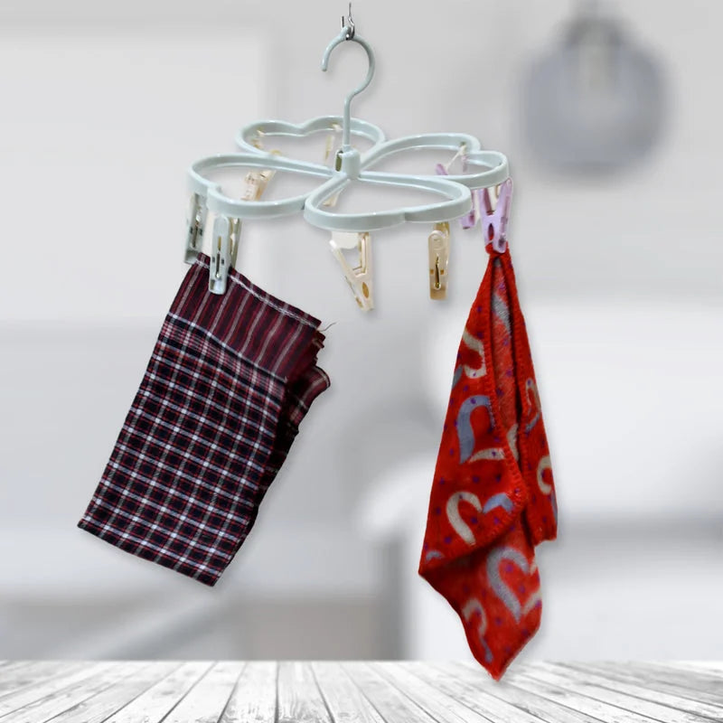 Heart-shaped drying rack with clips holding hanging cloths