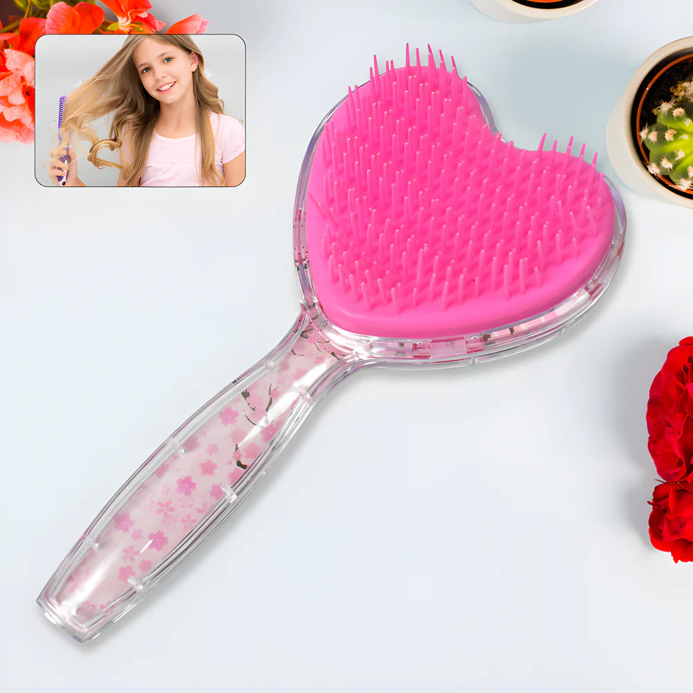 Heart-shaped glitter hair brush with pink bristle pad and clear handle