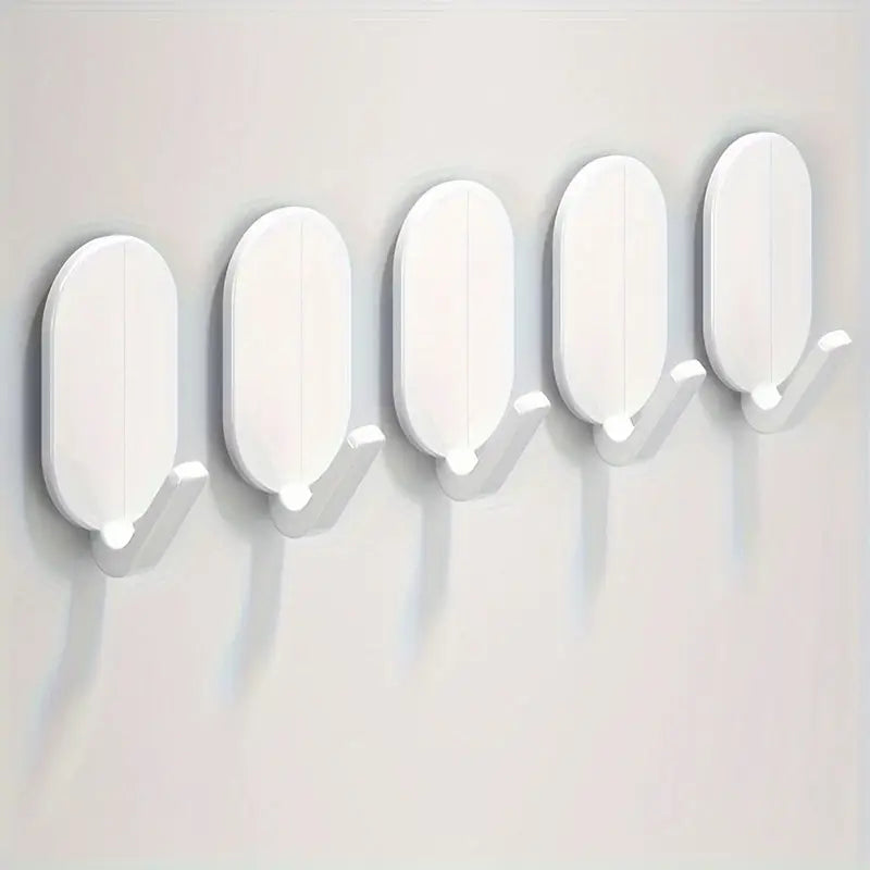 Set of white adhesive hooks with oval backplates and small mounting pegs