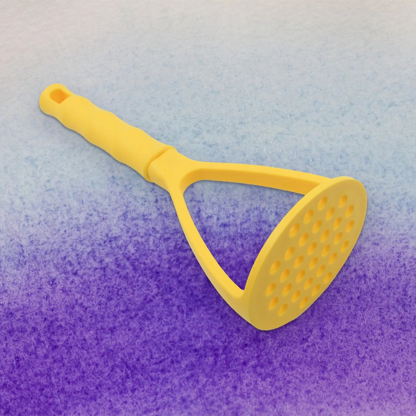 Yellow food masher with long handle and perforated mashing head