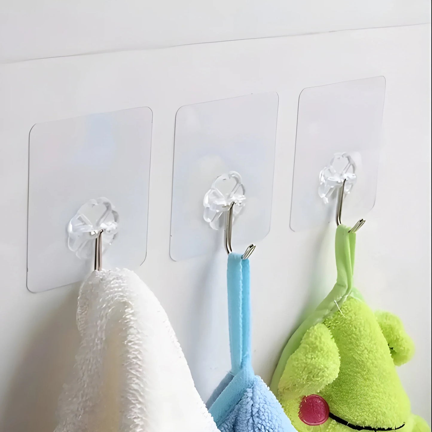 Heavy-duty wall hooks with clear mounting plates, holding towels in white, blue, and green