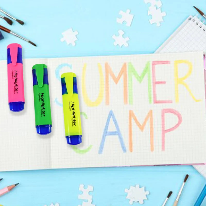 Set of highlighter pens in pink, green, and yellow on lined notebook paper.