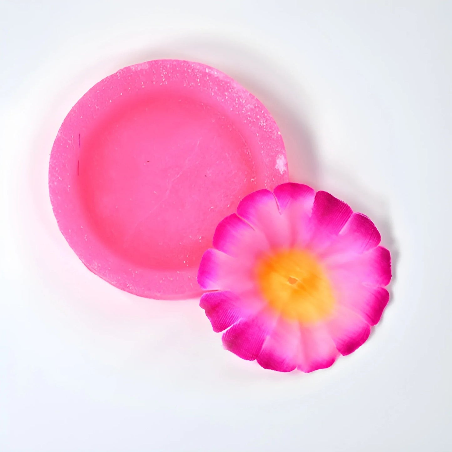 Pink bathroom freshener block with flower-shaped scent piece