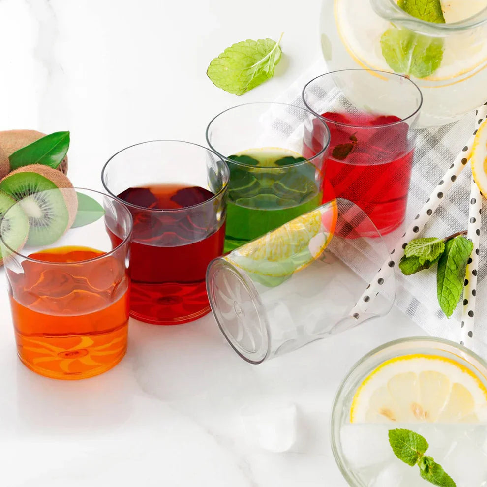 Clear unbreakable glass set of drinking tumblers with assorted colored drinks