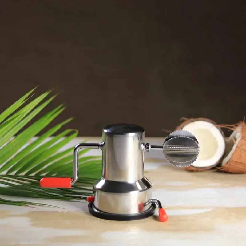 Manual coconut scraper machine with stainless base and serrated blade; red handle accents