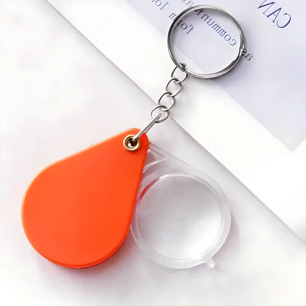 Orange teardrop keychain pocket magnifier with clear lens and metal split ring