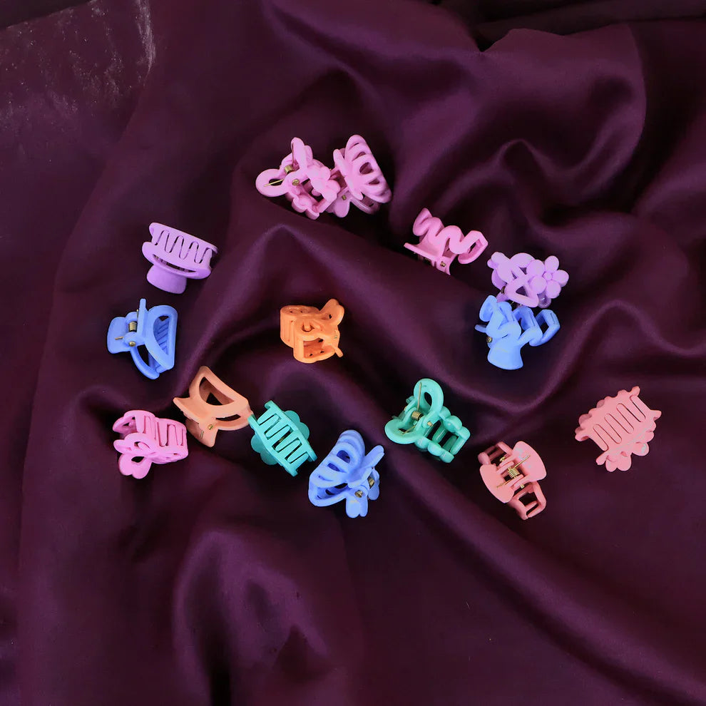 Assorted mini hair claw clips in pastel pink, purple, blue, orange, and teal